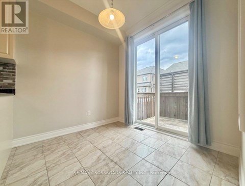A room with a sliding glass door leading to a balcony.