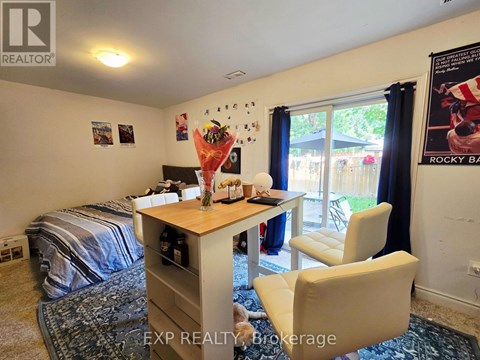 A bedroom with a bed, desk, and chair.