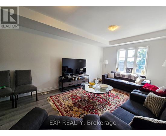 A living room with a rug and a coffee table.