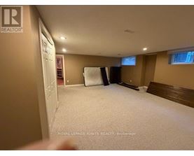 A bedroom with a bed, a window, and a closet.