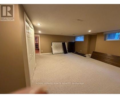 A bedroom with a bed, a window, and a closet.