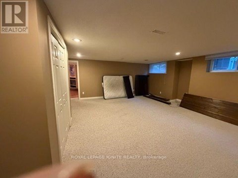 A bedroom with a bed, a window, and a closet.