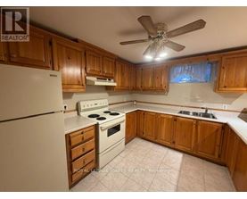 A kitchen with wooden cabinets and a white refrigerator.
