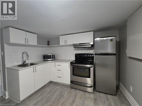A kitchen with white cabinets and stainless steel appliances.