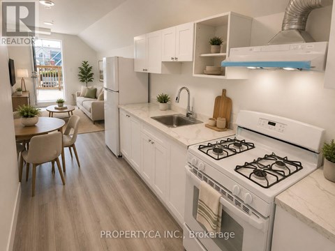 A modern kitchen with white appliances and wooden floors.