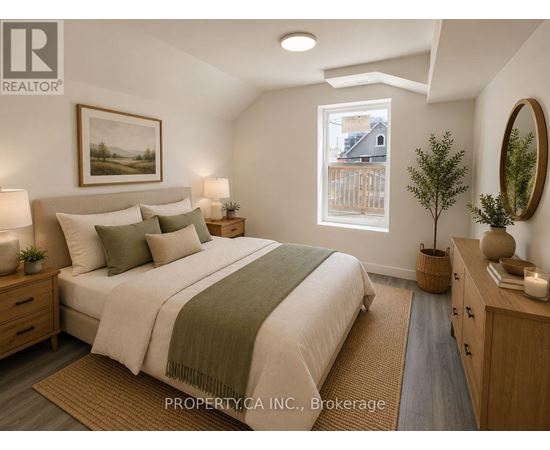 A bedroom with a large bed, a window, and a painting on the wall.