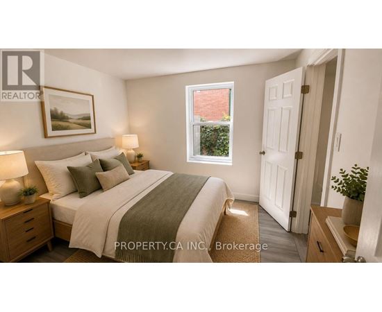 A bedroom with a bed, nightstands, and a window.