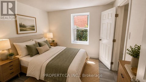 A bedroom with a bed, nightstands, and a window.