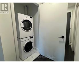 A white washer and dryer in a small room.