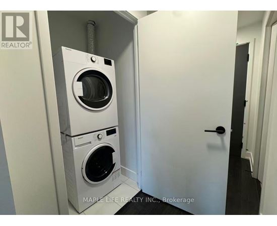 A white washer and dryer in a small room.
