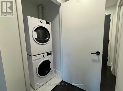 A white washer and dryer in a small room.