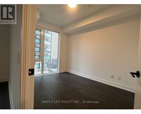 A room with a door and a window with a view of a city.