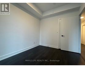 A room with a white door and a white wall.