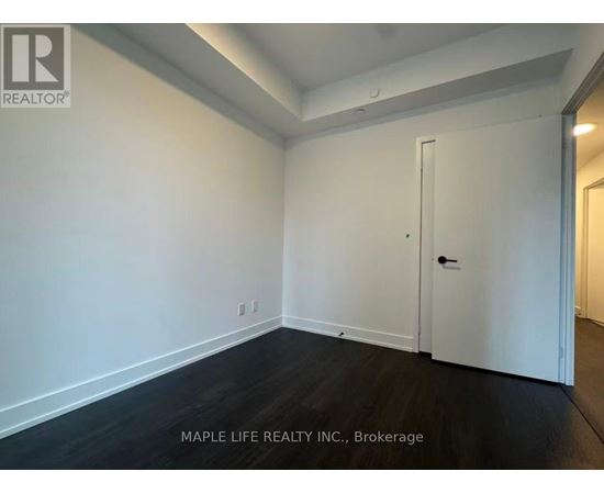 A room with a white door and a white wall.