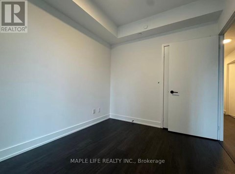 A room with a white door and a white wall.