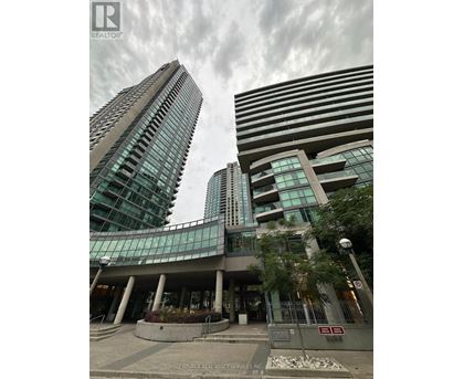 A modern building with glass windows and a curved entrance.