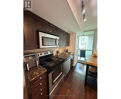 A kitchen with a stove top oven and microwave.