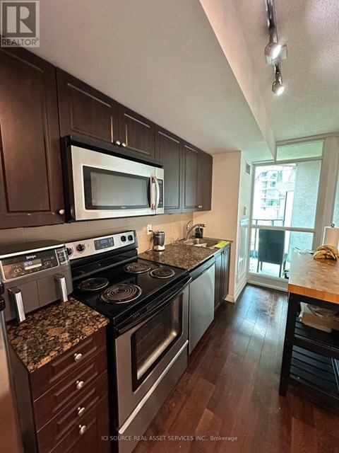A kitchen with a stove top oven and microwave.