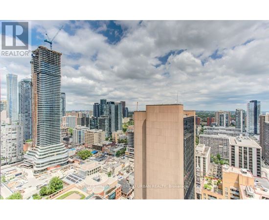 A cityscape with tall buildings and a clear sky.