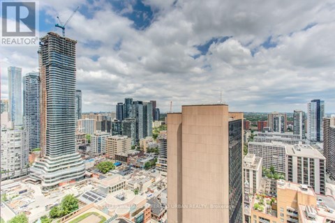 A cityscape with tall buildings and a clear sky.