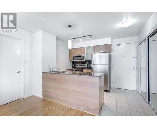 A kitchen with a wooden counter and white appliances.