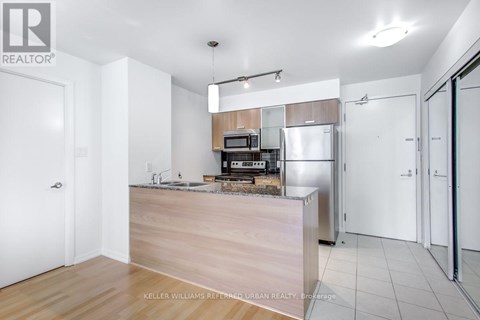 A kitchen with a wooden counter and white appliances.