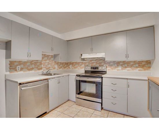 A kitchen with a stove, oven, and refrigerator.