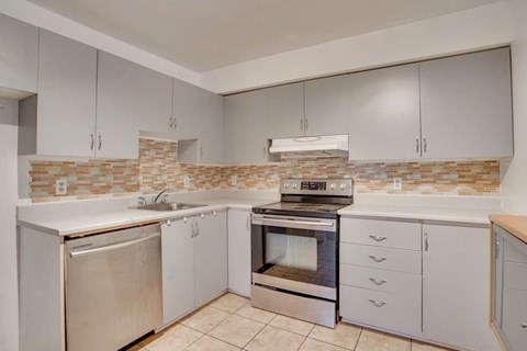 A kitchen with a stove, oven, and refrigerator.