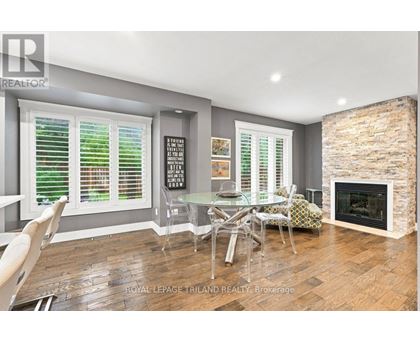 A dining room with a fireplace and a glass table.