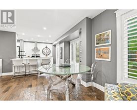 A modern kitchen with a glass table and chairs.