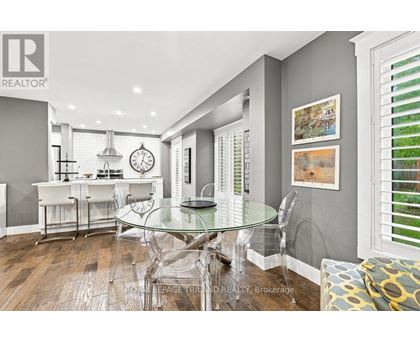 A modern kitchen with a glass table and chairs.