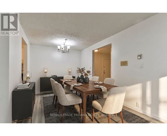 A dining room with a wooden table and chairs.