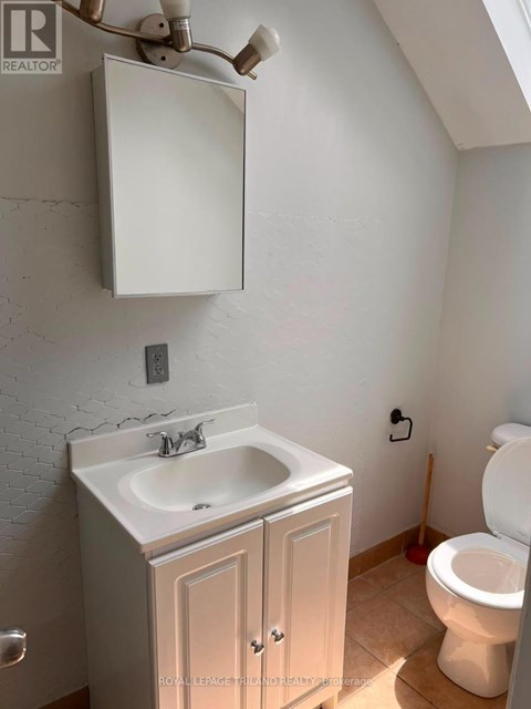 A white sink with a cabinet underneath it.