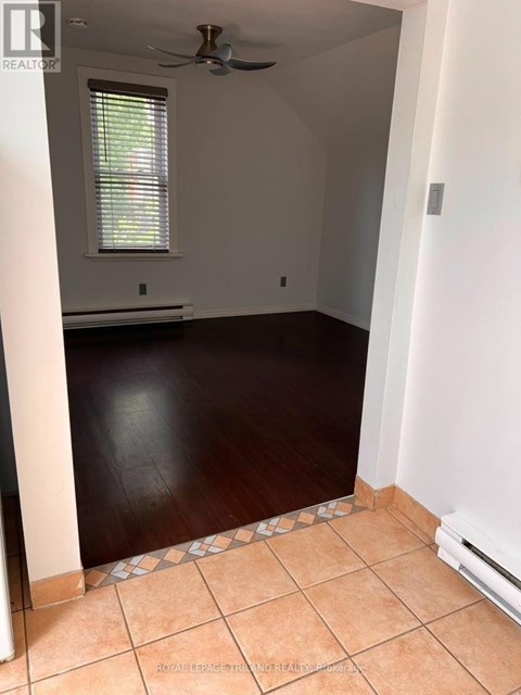 A room with a ceiling fan and a window.