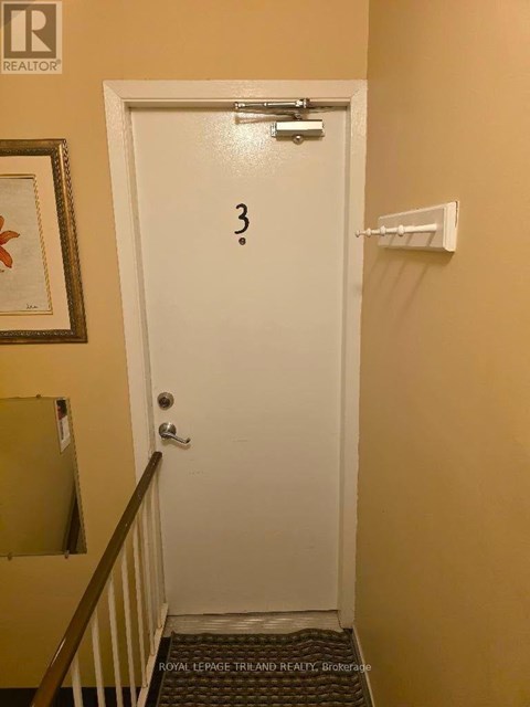 A white door with a number 3 written on it.