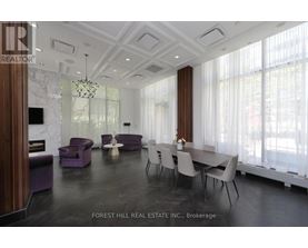 A dining room with a table set for six with chairs around it.