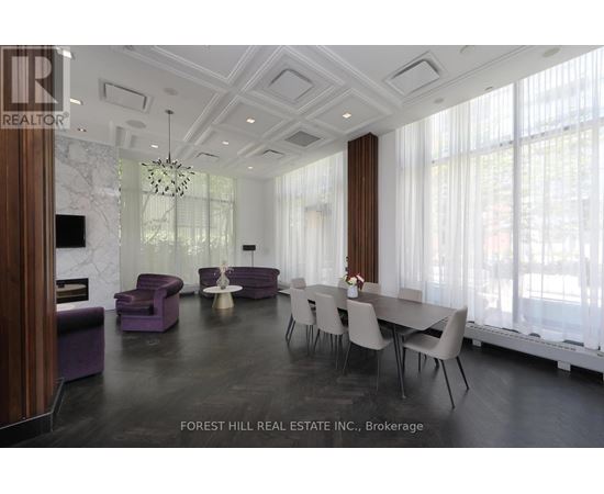 A dining room with a table set for six with chairs around it.