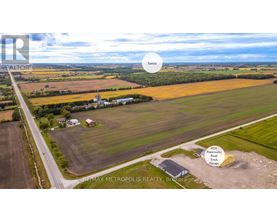 An aerial view of a rural area with a REMAX METROPOLIS REALTY sign.