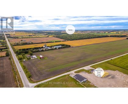 An aerial view of a rural area with a REMAX METROPOLIS REALTY sign.