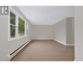 A room with a window and wooden flooring is available for rent.