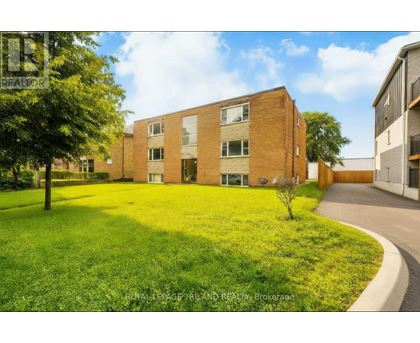 A building with a green lawn in front of it.