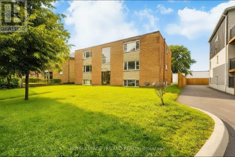 A building with a green lawn in front of it.