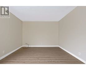 A room with a wooden floor and beige walls.