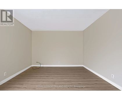 A room with a wooden floor and beige walls.