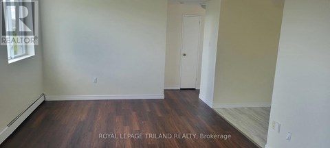 A room with wooden floors and white walls.