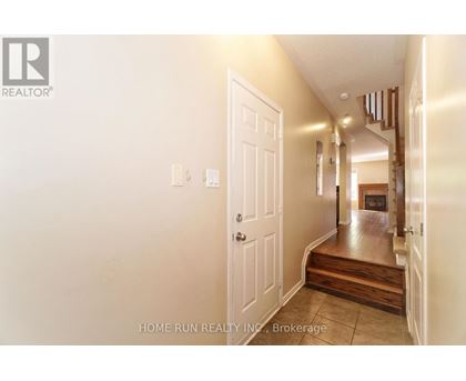 A hallway with a white door and a logo on the wall.