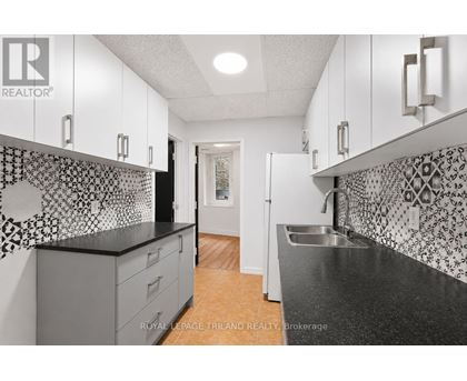 A kitchen with black and white tiles on the backsplash.