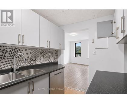 A kitchen with a sink and a counter top.