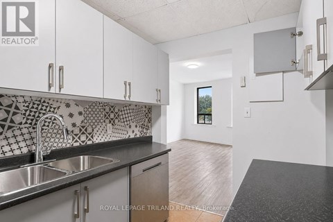 A kitchen with a sink and a counter top.