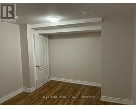 A room with a door and a brokerage sign.